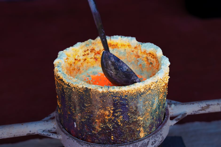 Close-up of molten gold in a crucible, showcasing the smelting process at a Bangkok foundry.