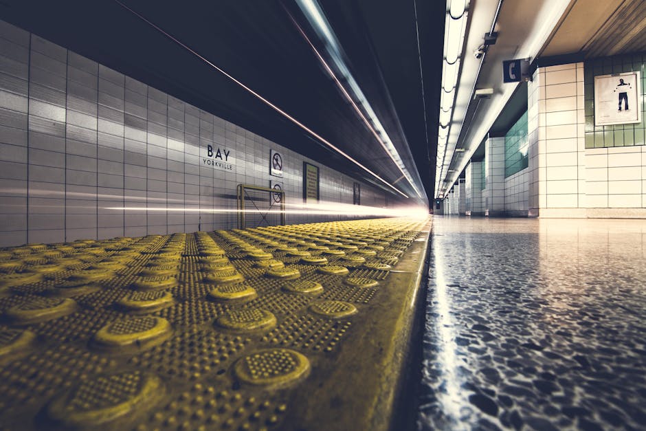Low angle view of a fast-moving train at Bay Yorkville subway station with blurred motion.